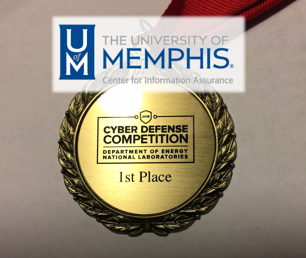 Cyber Defense Competition, Department of Energy National Laboratories 1st Place Medal. The University of Memphis, Center for Information Assurance Logo is covering the top of this picture